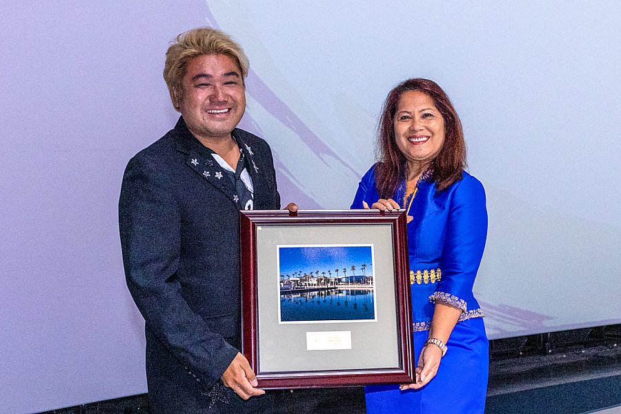 Man and woman holding a framed picture